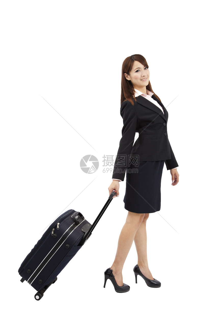 携带手提箱旅行的女商务人士图片