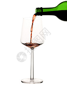 将红酒瓶放在玻璃杯上玻璃泡沫酒杯瓶子白色酒精气泡宏观红色液体背景图片