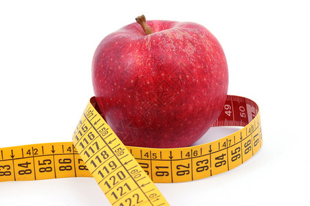 苹果和白色的测量胶带红色减肥控制磁带腰部饮食食物损失疾病医疗背景图片