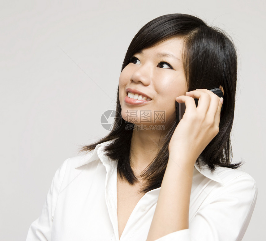 在电话里细胞工作成人管理人员商业喜悦办公室微笑快乐女性图片