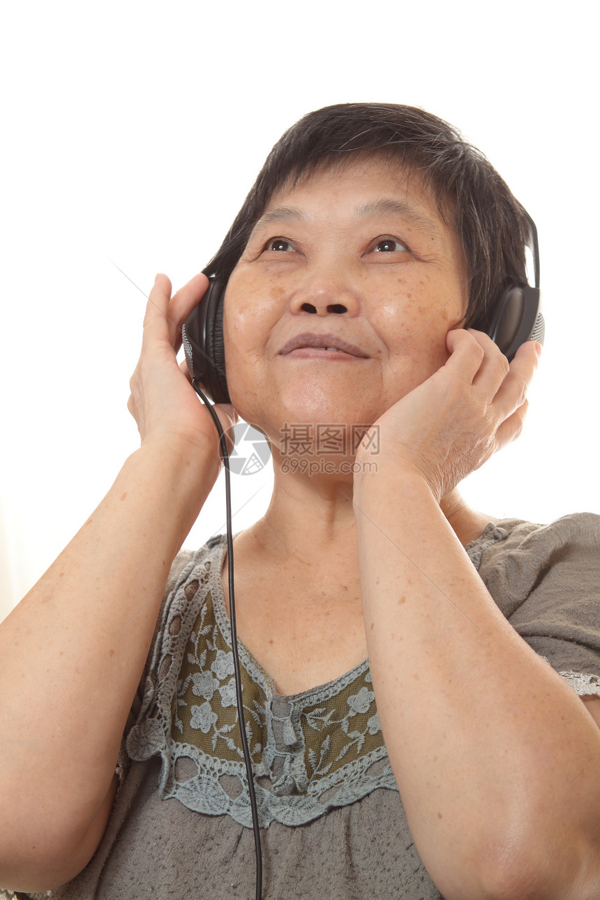 听耳机音乐的年长妇女头发技术闲暇老年玩家女士手机电子产品长椅白色图片