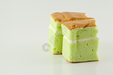 海绵蛋糕奶油状蛋糕绿色海绵棕色奶油背景图片