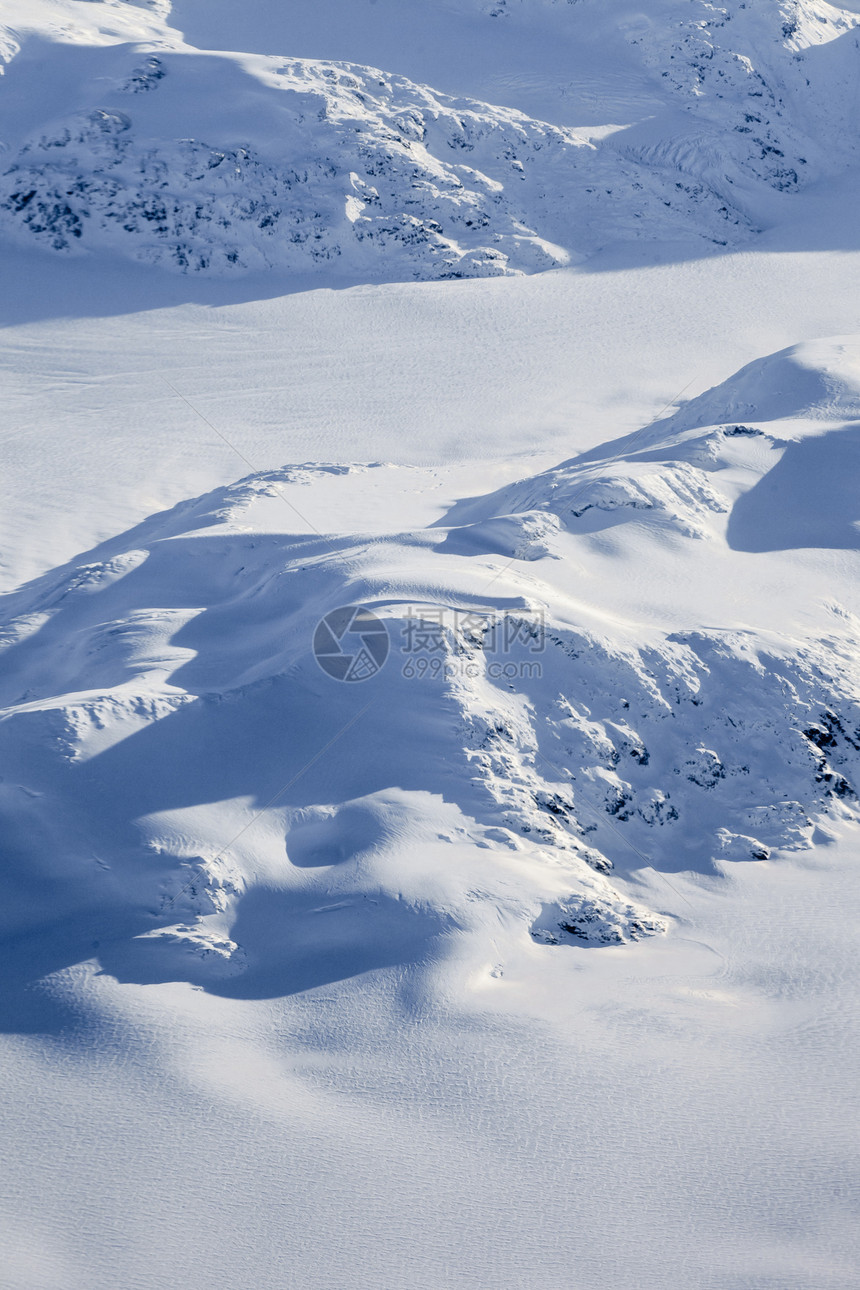 加拿大不列颠哥伦比亚BC积雪峰的空中观察寂寞自由旅行滑雪荒野顶峰蓝色太阳旅游雪帽图片