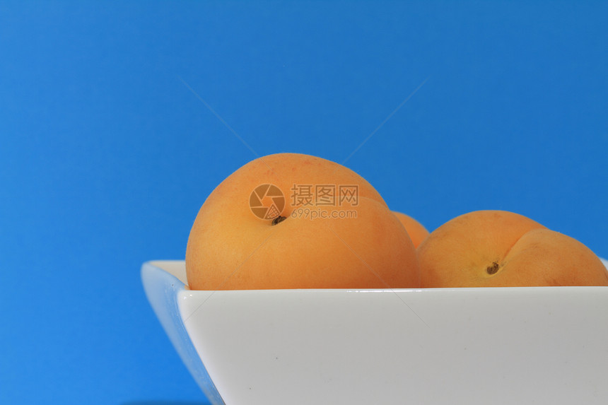 白碗上的杏子厨房香气植物蓝色营养重量矿物质饮食团体橙子图片
