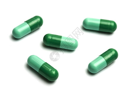 绿药丸药物药品医疗绿色宏观草本药片剂量白色背景图片