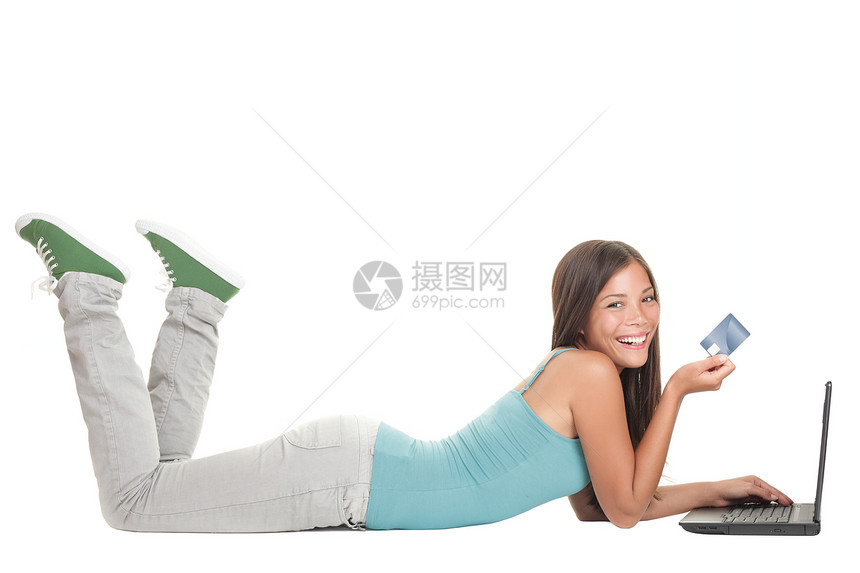 年轻妇女在笔记本电脑上网上购物蓝色女士互联网身体喜悦冲浪学生快乐技术信用图片