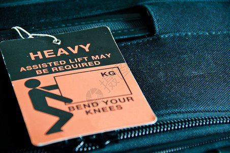 警告标签重型行李橙子假期商业公司运输案件标签游客旅行旅游背景
