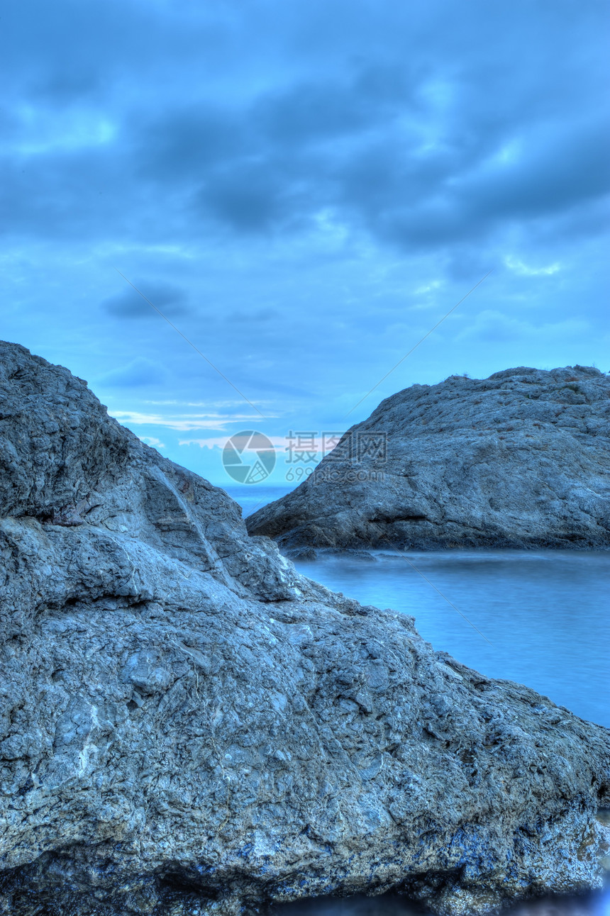 夜间的海海岸线海滩假期边缘地平线风暴石头阳光海景卵石图片