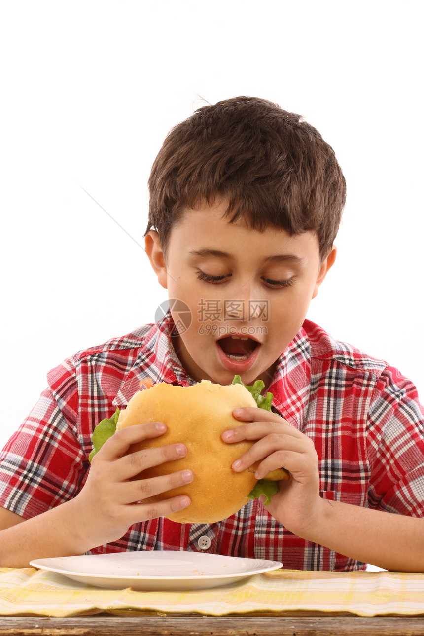 男孩吃一个大汉堡包营养午餐白色重量青少年孩子晚餐工作室小吃食物图片