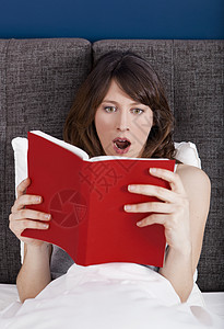 红色年轻情感阅读阅读书籍房间成人白色黑发睡衣震惊情感注意力卧室女士背景