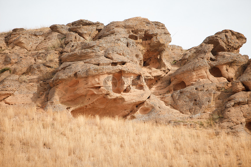 岩石荒野沙漠登山者旅行黄色场地天空石头丘陵风景图片