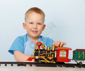 小男孩玩玩具机车小男孩照片火车蒸汽铁轨桌子选址黑色灰色微笑男生背景图片