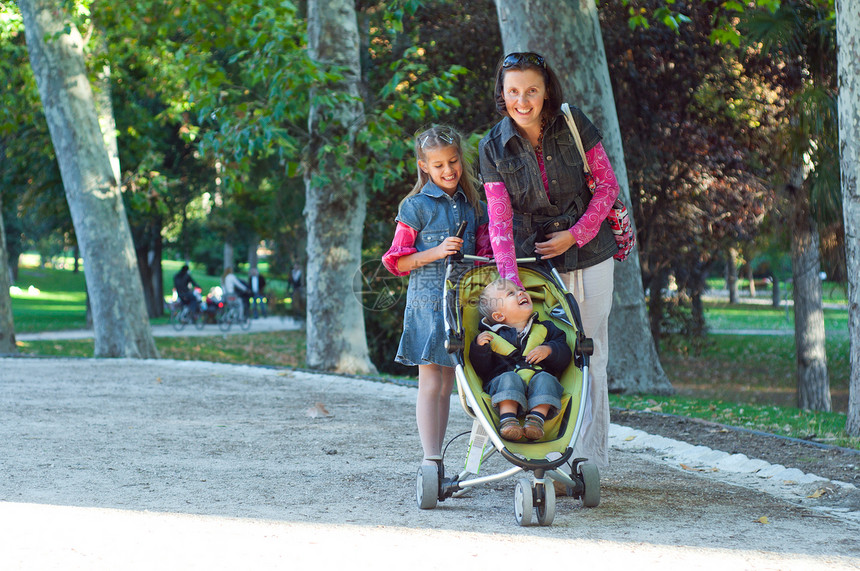 家庭步行闲暇童年女性婴儿车父母生活信仰城市活动公园图片