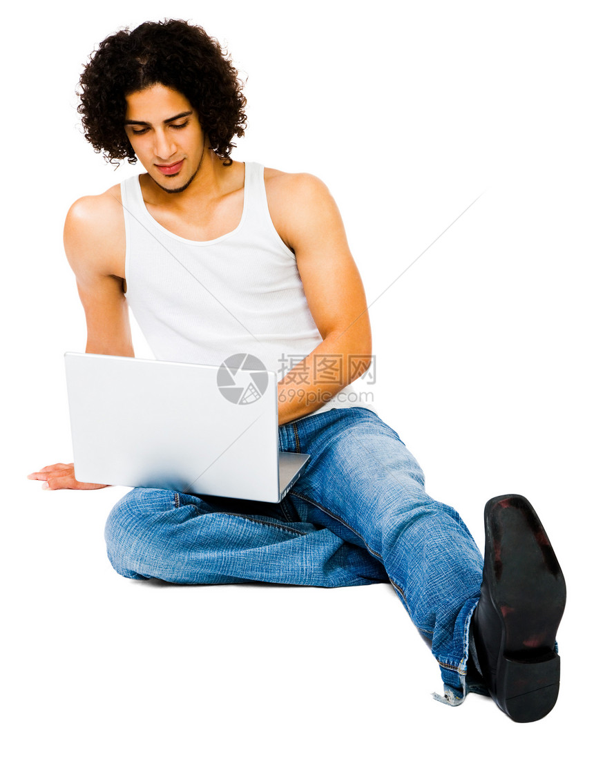 男人使用笔记本电脑姿势鞋类白色沟通技术闲暇互联网背心衣服牛仔裤图片