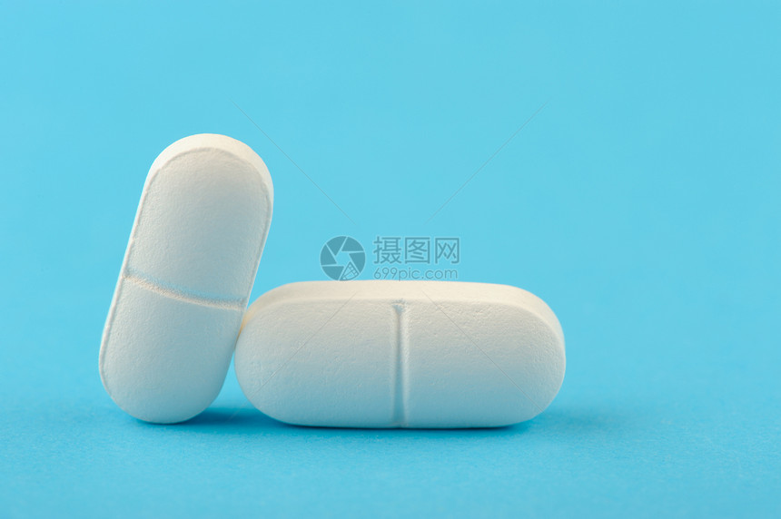 两张蓝色背景的白色平板电脑疾病阴影药片药品处方化学抗生素科学止痛药维生素图片