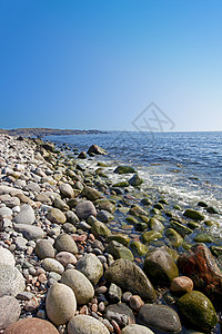 滚石蓝色石头海洋天空季节性岩石滚动圆形峡湾波浪背景