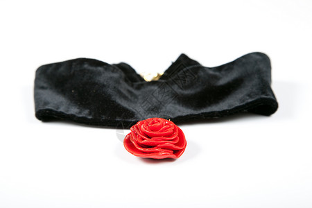 黑色天鹅绒上的领带红玫瑰 用塑料粘土制成的手背景图片
