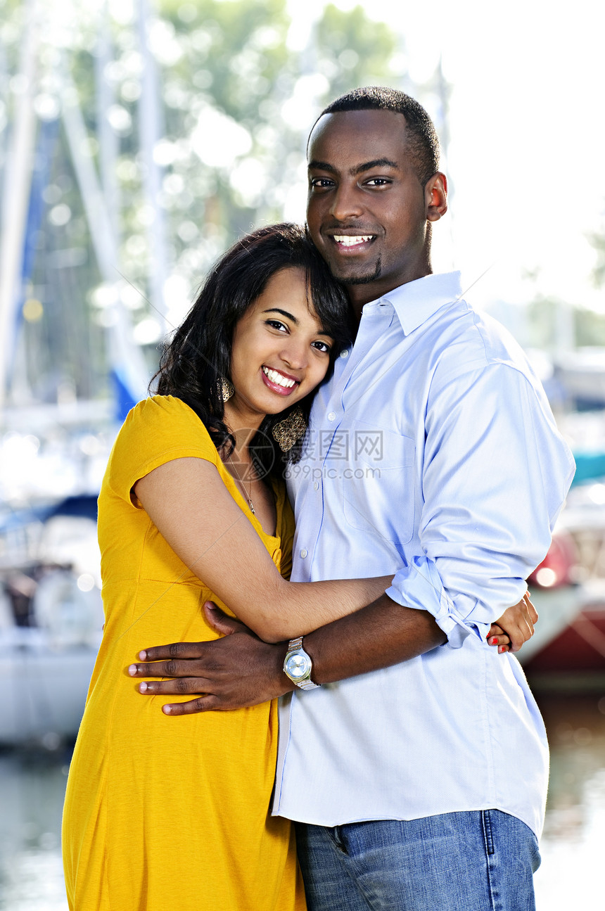 快乐的情侣拥抱微笑幸福闲暇男人黑色少数民族港口女士帆船图片