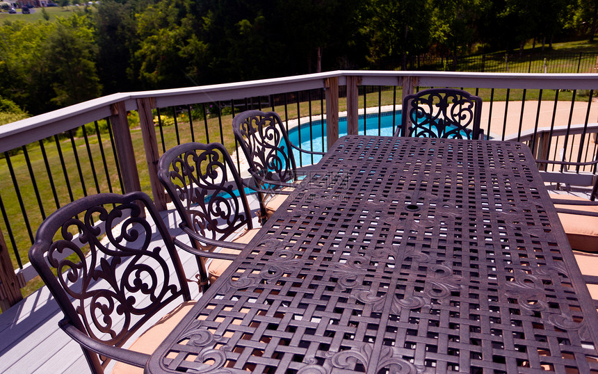 在游泳池旁边的甲板上坐席和椅子露台游泳院子园林后院奢华娱乐绿化草地住宅图片