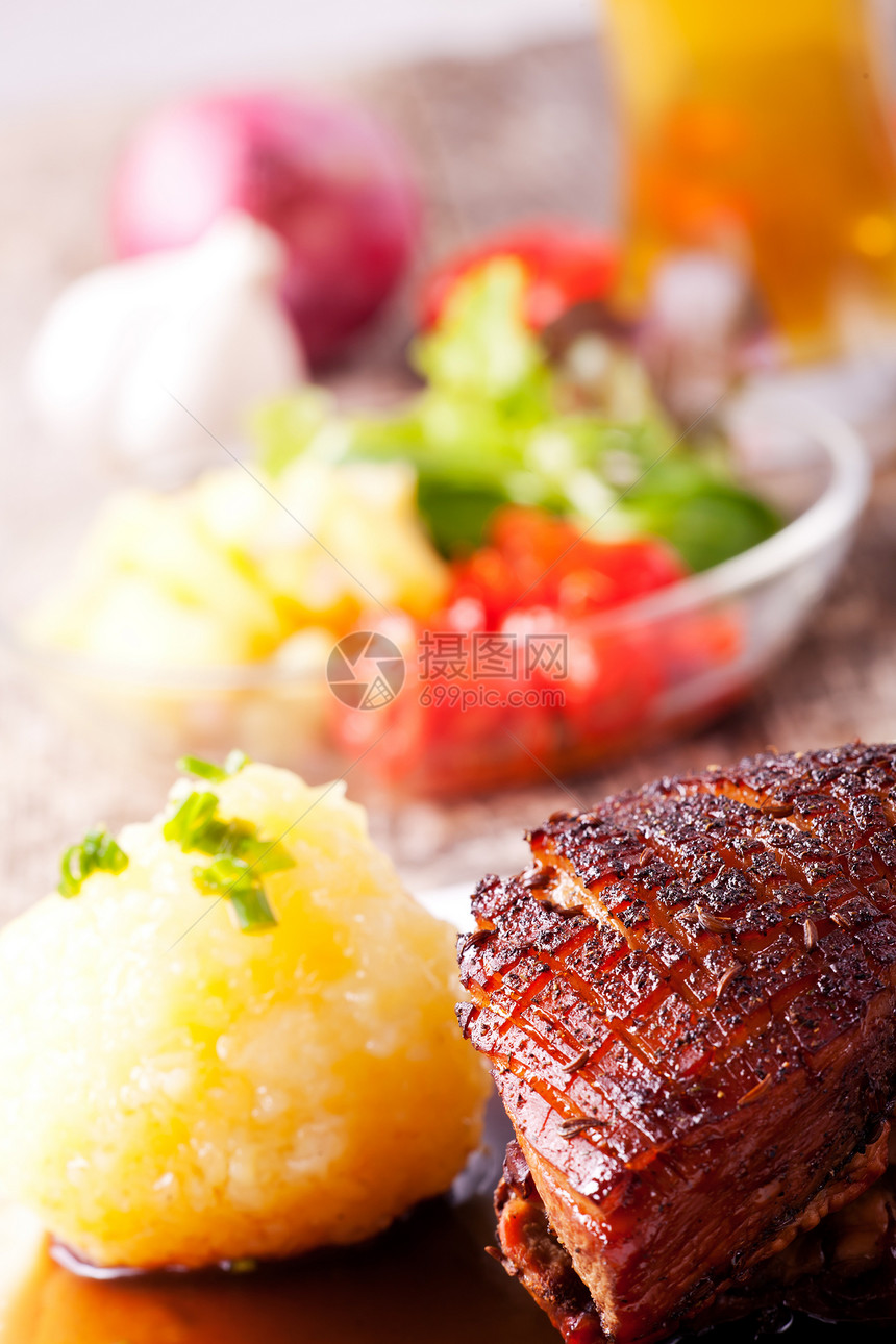 特写巴伐利亚烤猪肉盘食物乡村木头脆皮美食沙拉腰部棕色关节盘子图片