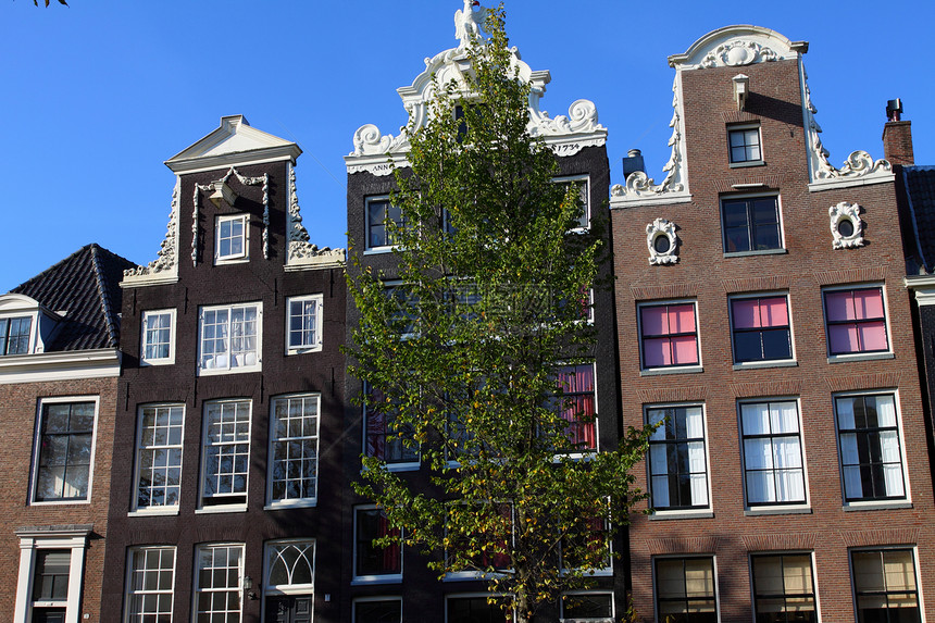 阿姆斯特丹的房屋建筑天空特丹旅行蓝色旅游运河风格战线自行车历史图片