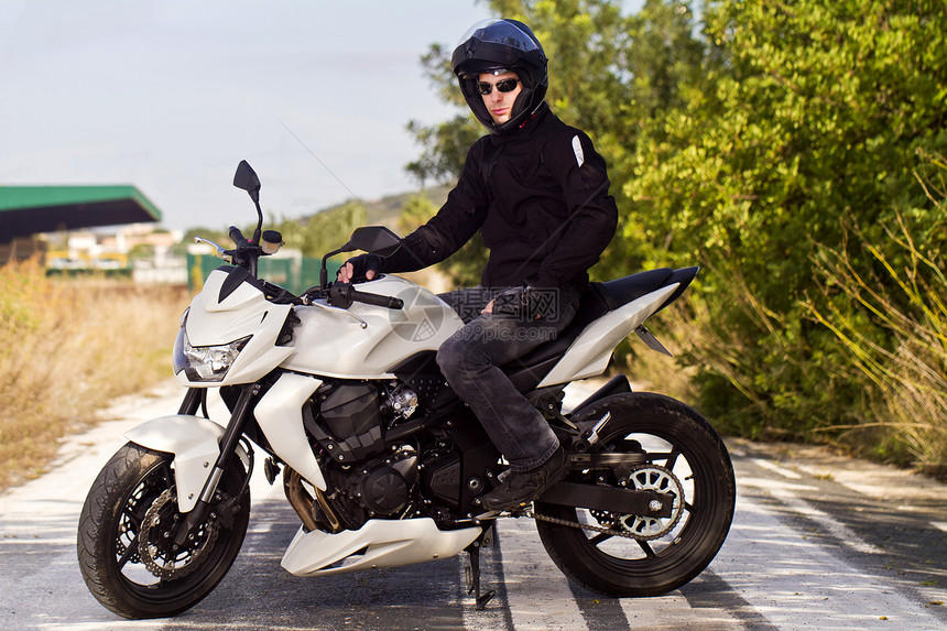 骑摩托车的男人车辆小路发动机司机男生头盔青年植被机器沥青图片