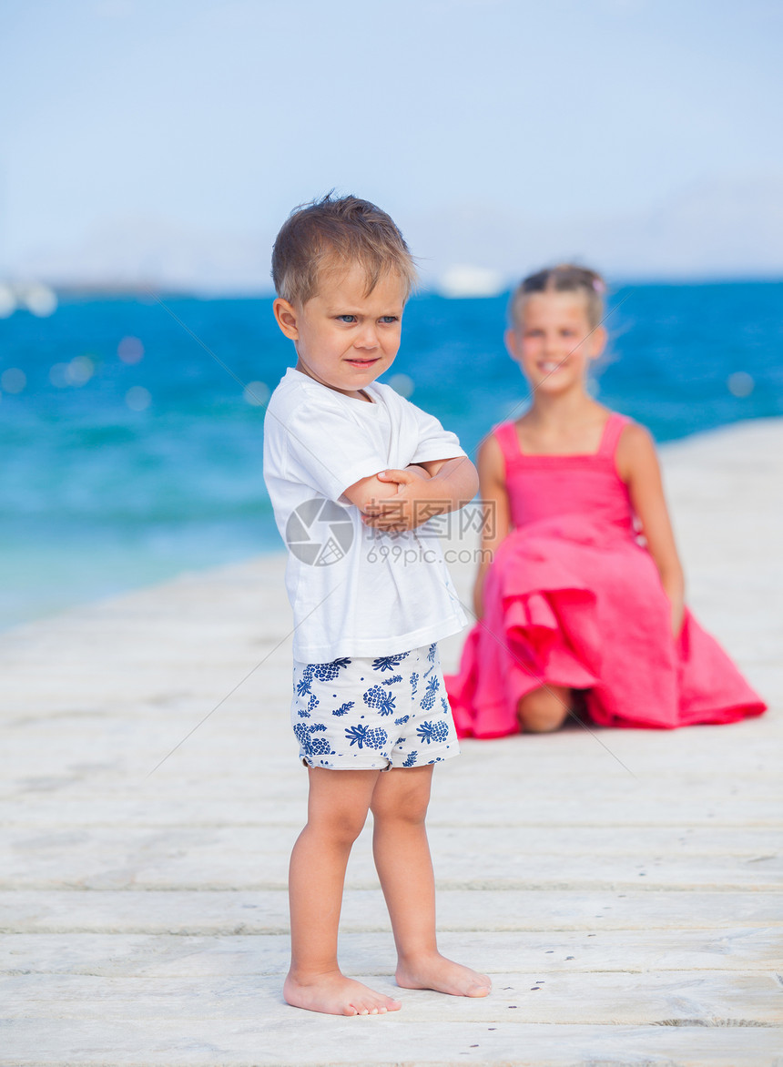 男孩和他妹妹在码头散步跑步女性闲暇蓝色假期海滩女孩婴儿海洋童年图片