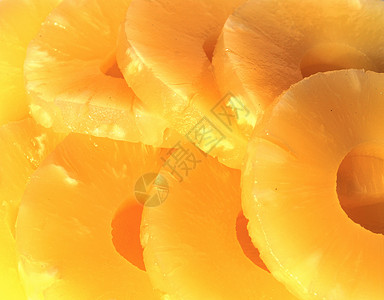 黄罐头菠萝环 素食食物戒指生活方式黄色圆圈菠萝横截面水果背景图片