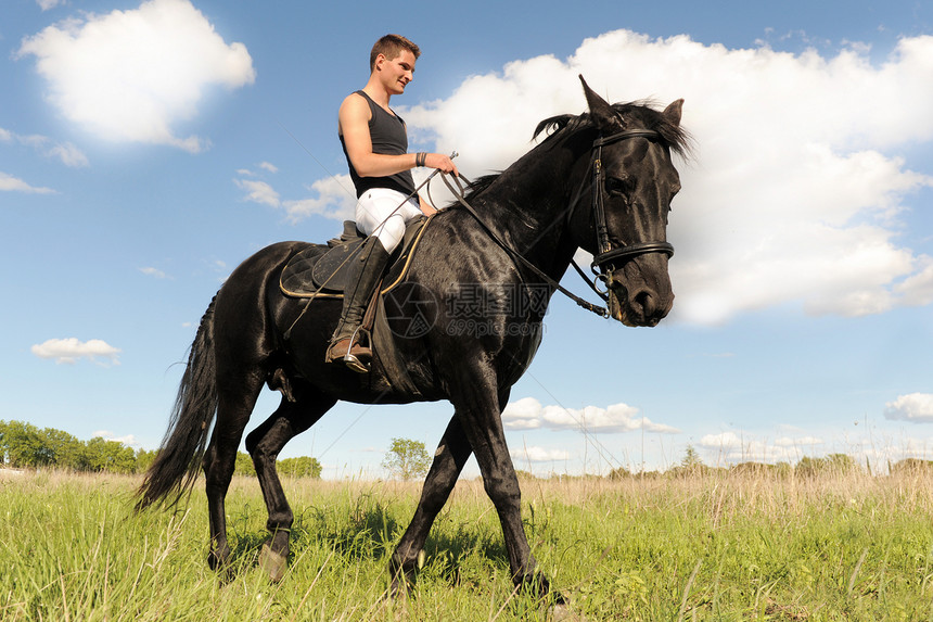 青年男子和马马黑色运动宠物马术蓝色男性场地骑马动物白色图片