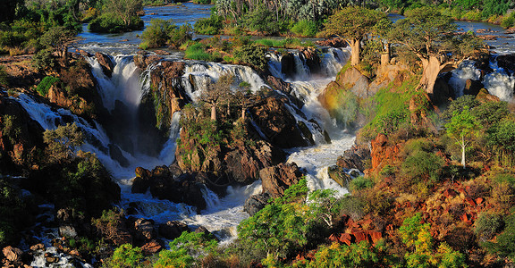 Epupa 瀑瀑图全景 纳米比亚阴影急流洪水巨石日落彩虹太阳悬崖峡谷岩石背景图片