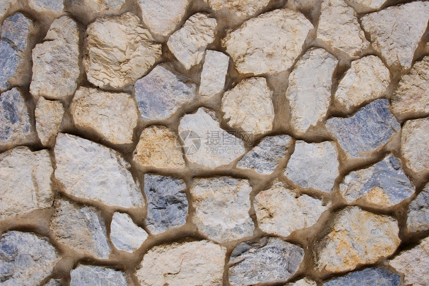 石墙背景水泥岩石蓝色棕色历史黄色石膏砂浆砖块片岩图片