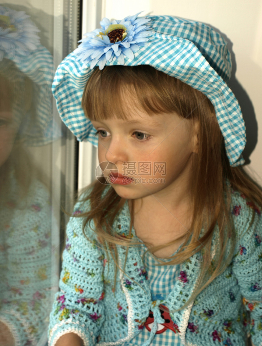 穿着蓝裙子的女孩微笑眼睛童年乐趣场地孩子窗台婴儿金发女性图片