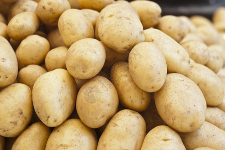 孔眼供出售的新土豆马铃薯腐烂园艺午餐生长拨款芯片衰变食物植物背景
