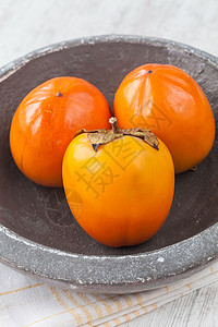 Persimmon 双环西蒙生物营养情调异国橙子维生素水果卡其色背景图片