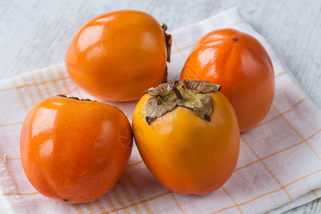 Persimmon 双环西蒙水果营养异国维生素橙子生物情调卡其色背景图片