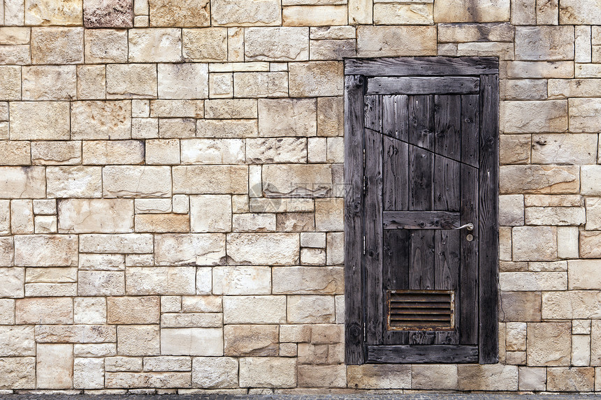 格隆盖砖墙上的旧木门风化木头场景石膏石头入口砂岩建筑学脆弱性水泥图片