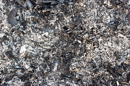 树叶烧焦后产生的灰烬木头煤炭灰尘灰色黑色背景图片