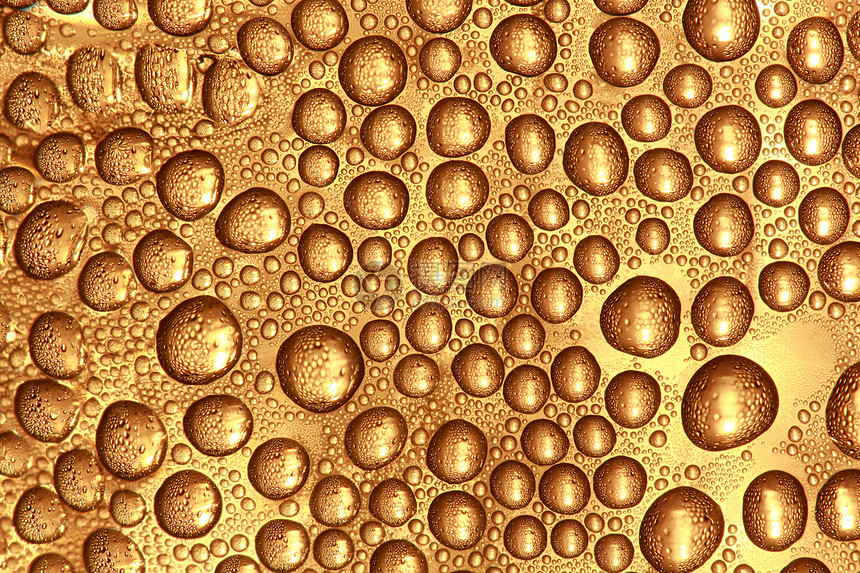 玻璃表面的滴水宏观飞沫液体反射黄色画幅阴影金子饮料水晶图片