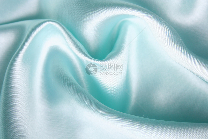 平滑优雅的蓝色丝绸作为背景感性材料折痕银色生产纺织品织物投标版税曲线图片