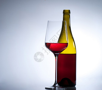 红酒一杯一杯红酒和一瓶酒红色面对者高脚杯白色用餐水晶酒杯液体酒精坡度背景