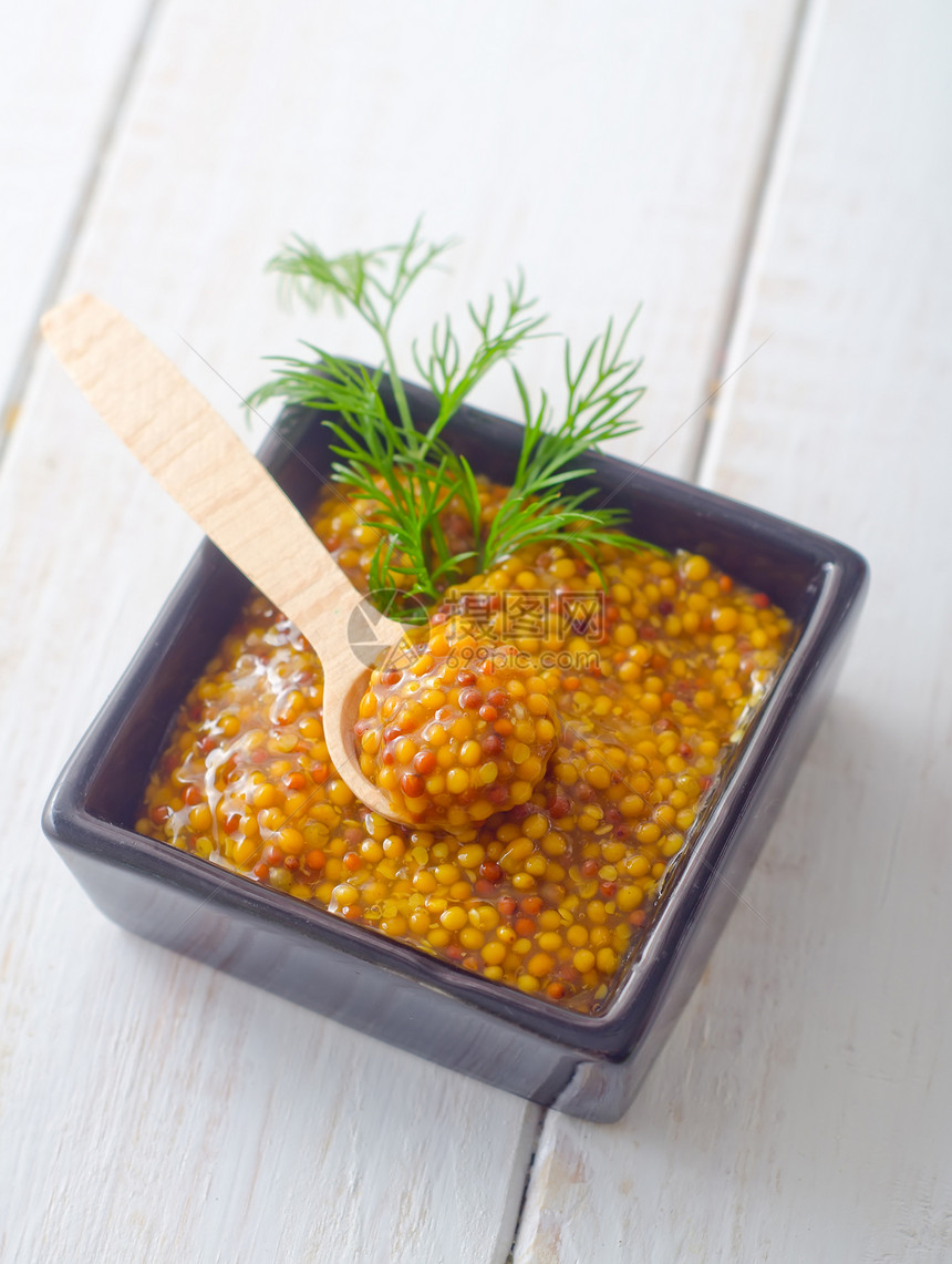 桌上黑碗里的芥末食谱食物味道烹饪美味叶子植物敷料美食芸苔图片