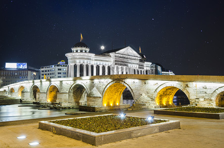 斯科普里拉美丽的旧石桥和马其顿在星空月月亮上的考古博物馆 以及背景