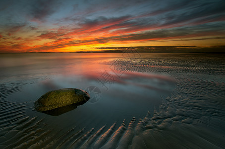 玛丽安德尔湾阿隆比湾天空橙子岩石黄色海滩红色日落低潮山脉海景背景