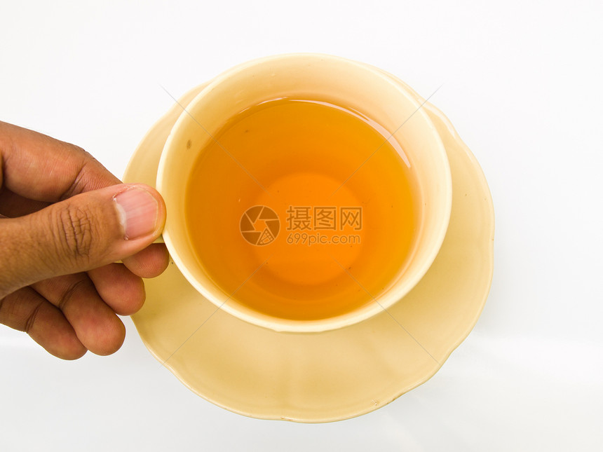 一只用手握着的茶杯 与白色背景隔绝早餐饮料时间花朵玻璃盘子液体杯子草本棕色图片