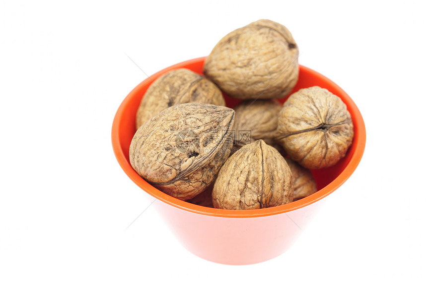 白纸上隔绝的碗中的胡桃豆类宏观食物摄影核桃坚果木头餐具力量小吃图片