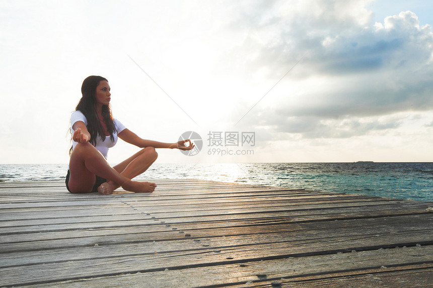 近海边的瑜伽妇女冥想活动保健行动福利卫生姿势海滩码头阳光沉思图片