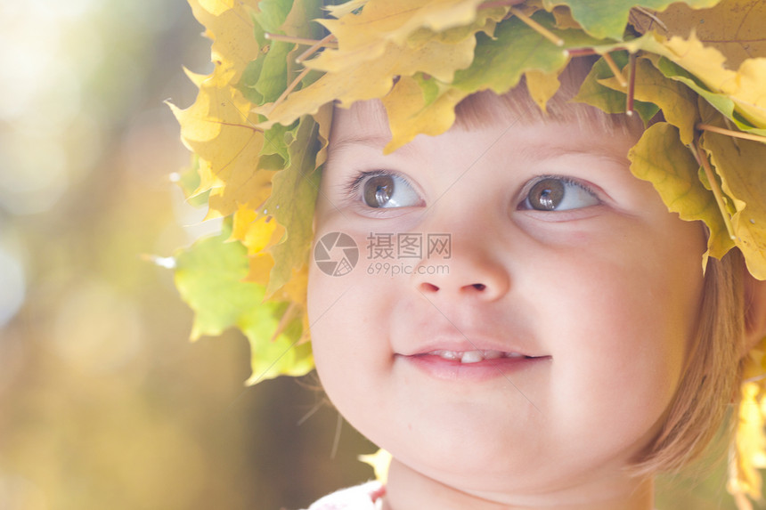 美丽的小女孩 在秋前秋叶的青树叶花圈中快乐女性幸福公园喜悦森林叶子黄色女孩乐趣图片