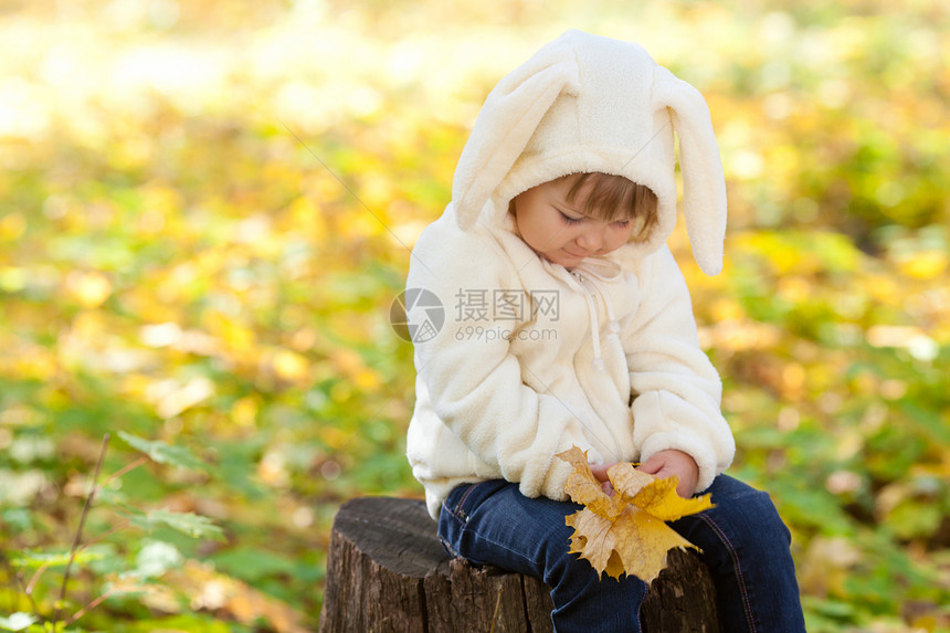 秋天森林中穿着装扮小兔子的漂亮女孩叶子毛皮兔子幸福公园喜悦橙子女孩童年戏服图片