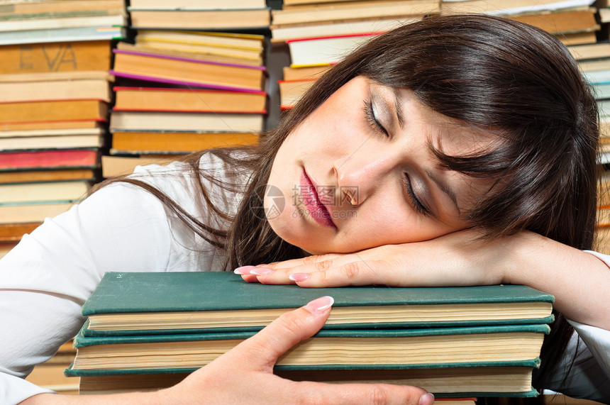 过度劳动的大学生沉睡在书本上图片