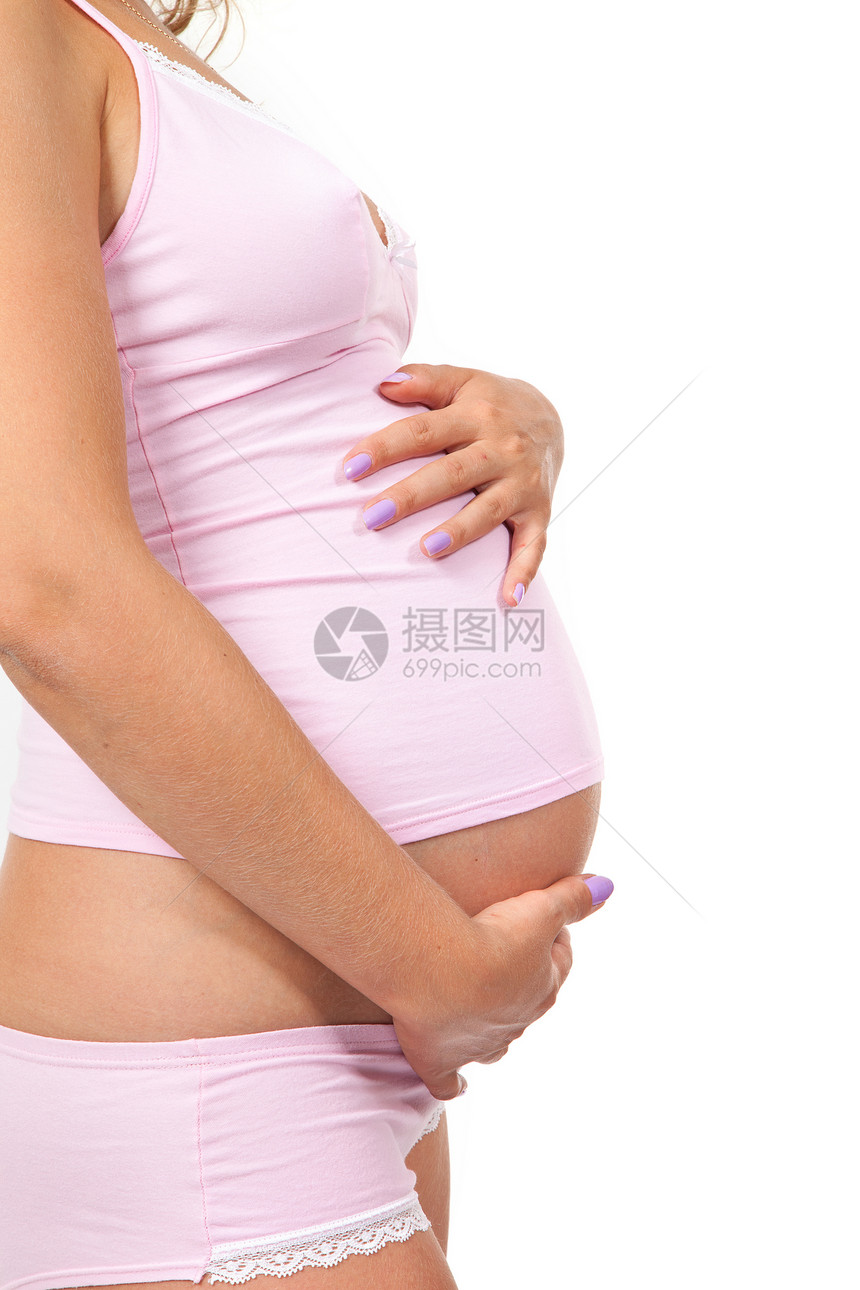 孕妇在抚摸她的肚子女士母性腹部母亲生活分娩衣服白色成人身体图片